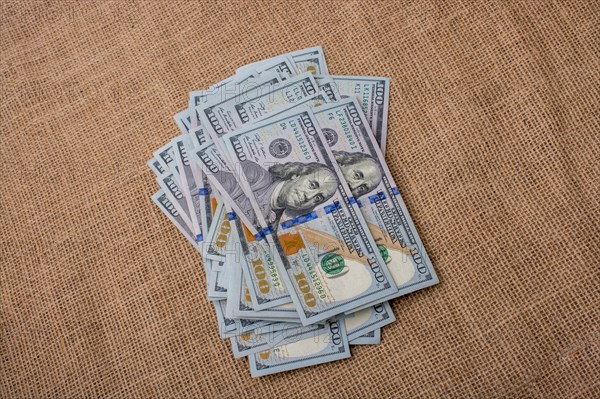 Banknote bundle of US dollar placed on a linen canvas