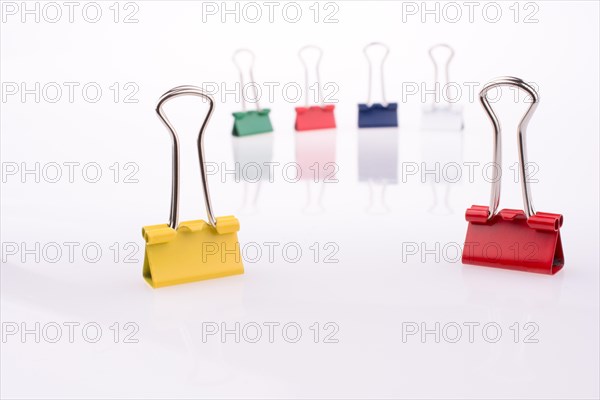 Colored paper clips on a white background