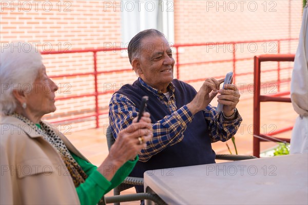 Two elderly people in the garden of a nursing home