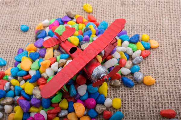 Pile of little colorful pebbles on wooden background