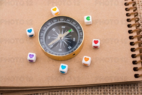 Heart cubes around a compass on canvas