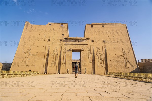 A young tourist entering the Temple of Edfu in the city of Edfu