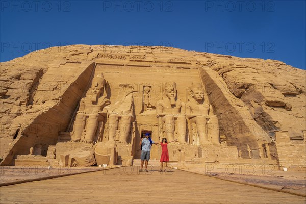 A couple of European tourists visit the Abu Simbel Temple in southern Egypt in Nubia next to Lake Nasser. Temple of Pharaoh Ramses II