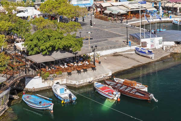 Fishing boats on Lake Voulismeni at the harbour promenade