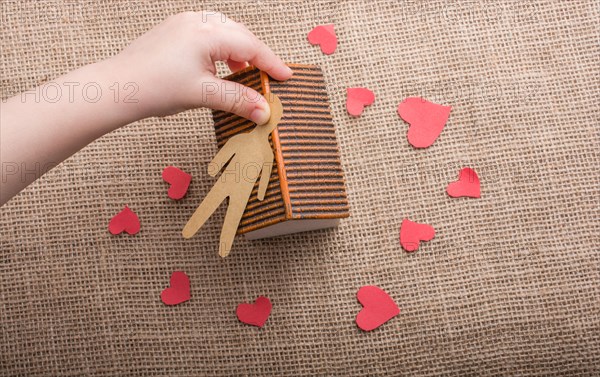 Heart shaped icons and paper house on canvas