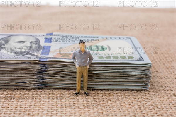 Man figurine found beside the bundle of US dollar banknote