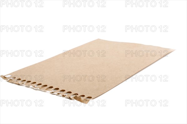 Sheet of brown torn notepaper on a white background