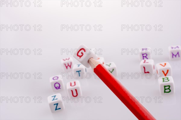 Pencil with Letter cubes on a white background