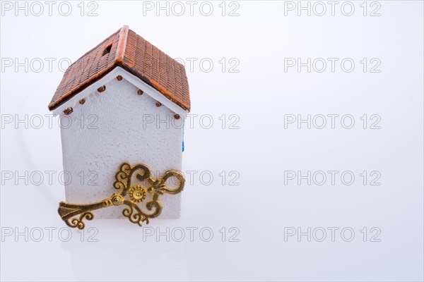 Key near a house on a white background