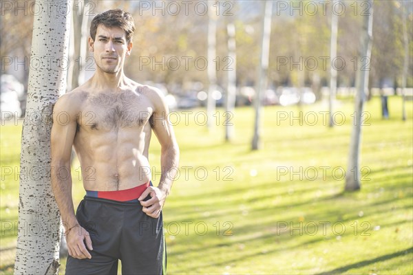 Attractive young man posing in the park after exercising