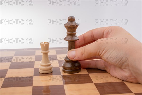 Person playing chess game making a move on board