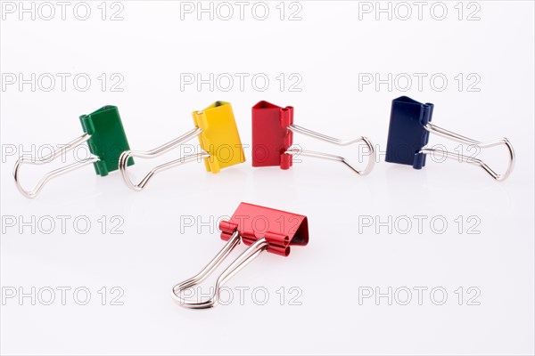 Colored paper clips on a white background