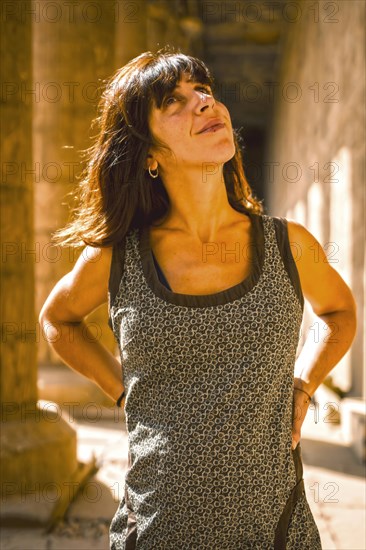 Portrait of a young brunette on the columns of the Edfu Temple near the city of Aswan. Egypt