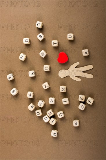 Letter cubes of made of wood and man figurine and heart shape