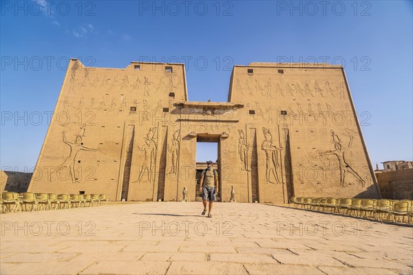 A young tourist entering the Temple of Edfu in the city of Edfu