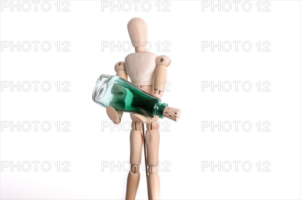 Wooden man holding a green bottle on white background
