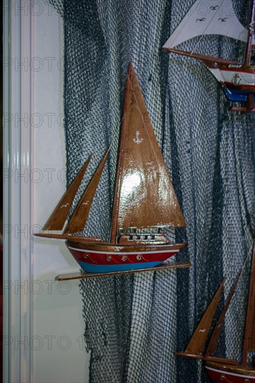 Mini size little colorful model sailboat in view