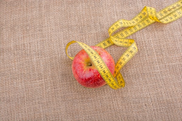 Health and diet concept with apple with a measurement tape