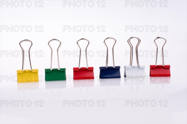 Colored paper clips on a white background