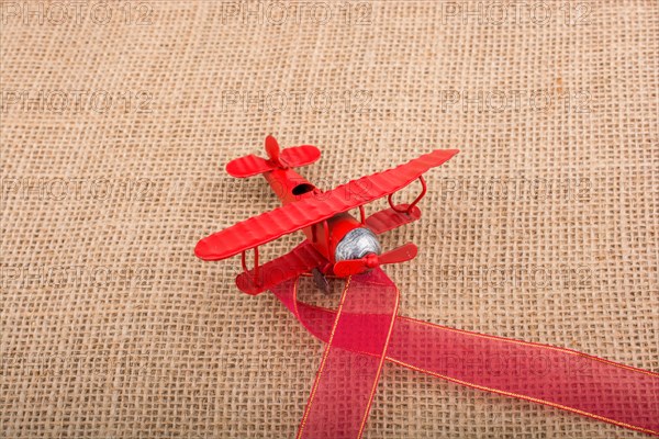 Toy airplane on a linen canvas background