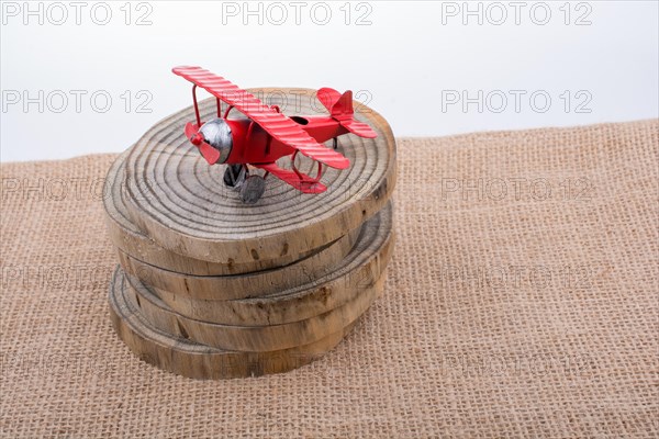 Red color toy plane is on a wooden texture