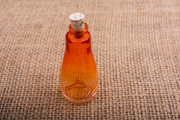 Colorful empty bottle placed on a linen canvas