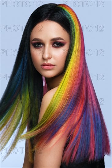 Portrait of beautiful woman with multi-colored hair and creative make up and hairstyle