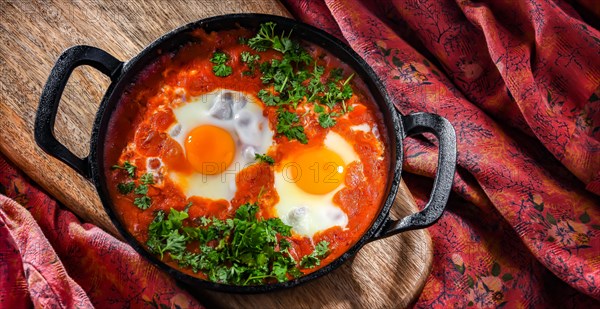 Shakshouka dish in a cast iron pan