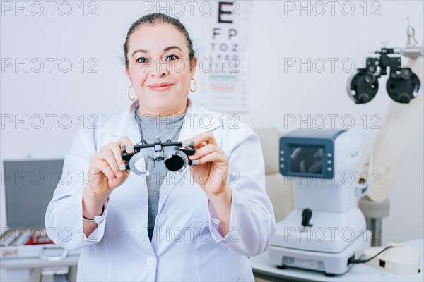 Portrait of optometrist holding messbrille lens in laboratory. Optometrist specialist holding optometric trial frame