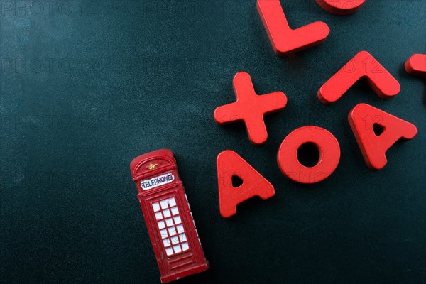 Telephone booth and colorful letters of Alphabet made of wood