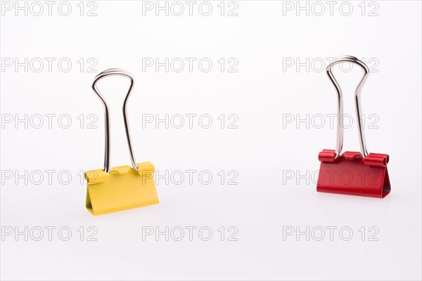 Colored paper clips on a white background