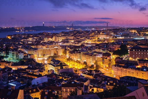 Night view of Lisbon famous view from Miradouro da Senhora do Monte tourist viewpoint of Alfama and Mauraria old city districts