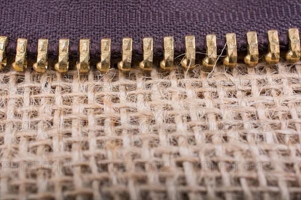 Closeup of a colorful zipper on linen canvas