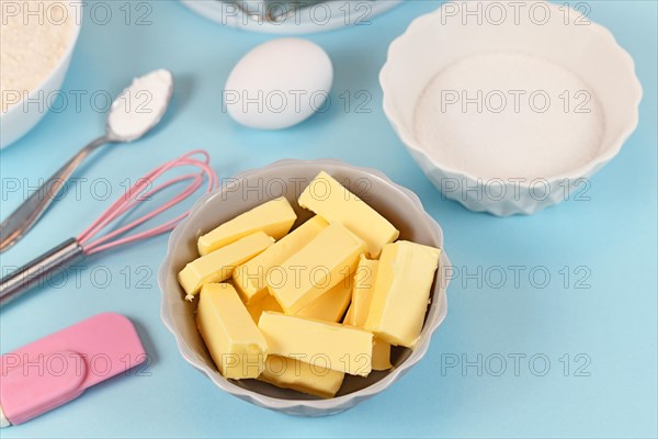 Butter cut in pieces for preparing dough for shortcrust cake base with sugar