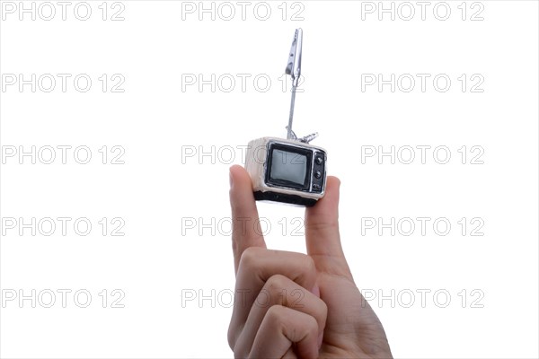 Child holding a tv set n his hand on a white background