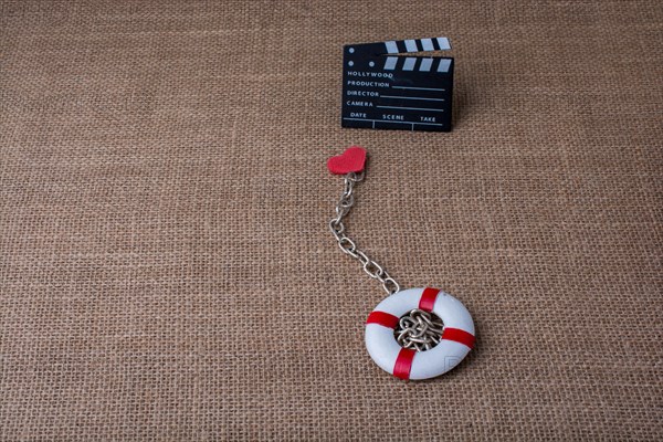 Heart attached to a life preserver and a cinema clapper