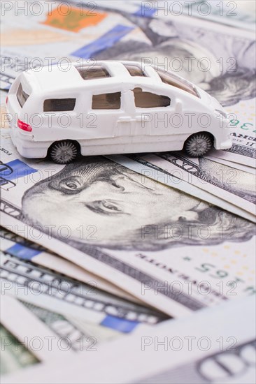 Model cars placed US dollar banknotes spread on ground