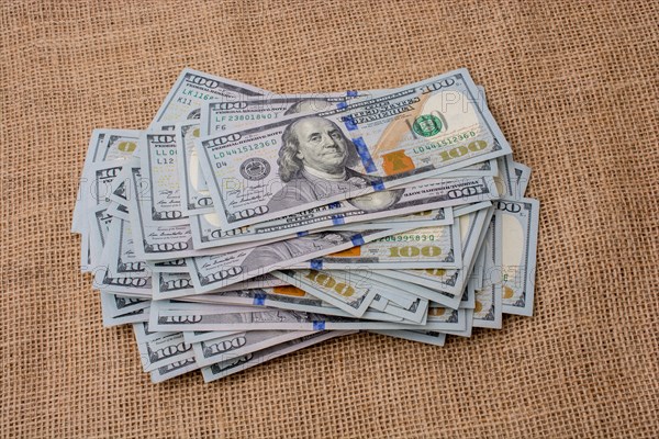 Banknote bundle of US dollar placed on a linen canvas