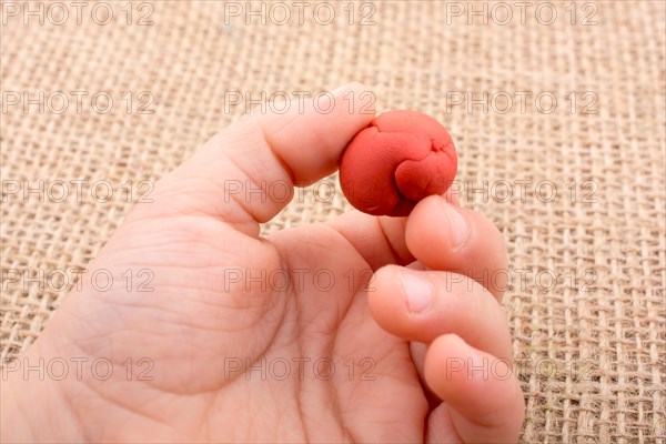 Hands holding Play Dough as Concept of sensetive education and therapy