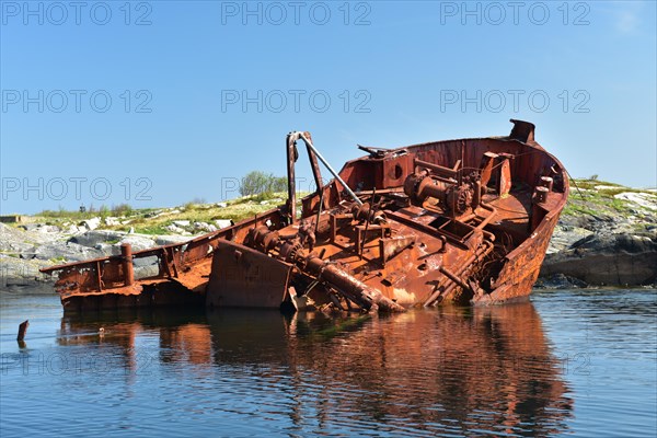 Rusty shipwreck on the Atlantic Strait in Norway