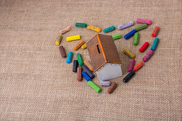 Globe in the middle of crayons form a heart shape