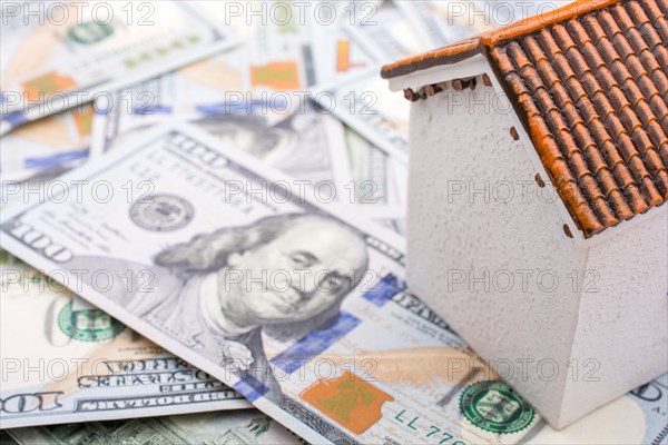 Model house is placed US dollar Banknotes on spread on the background