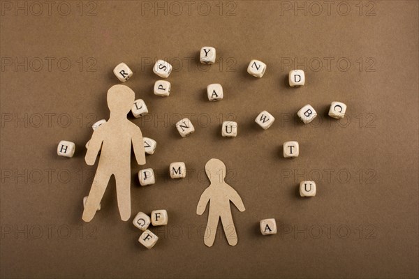 Letter cubes of made of wood and men figurine