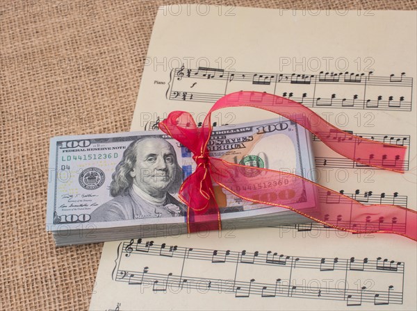 Banknote bundle of US dollar tied with colorful a ribbon