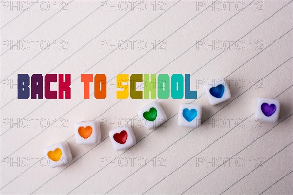 Colorful cubes with a heart placed on paper