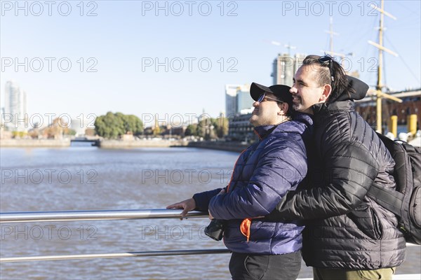 Tourist gay couple posing in Puerto Madero