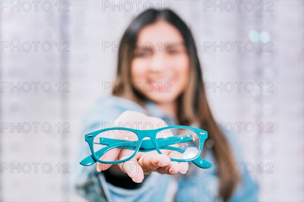 Girl hands showing some glasses in a store. Buyer showing glasses in a store. Happy girl holding glasses in palm hand in a store