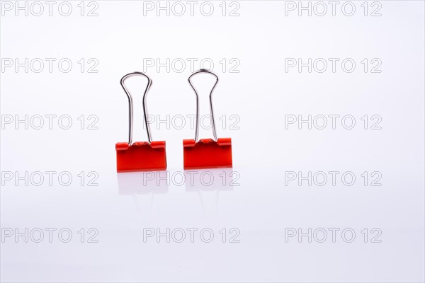 Colored paper clips on a white background