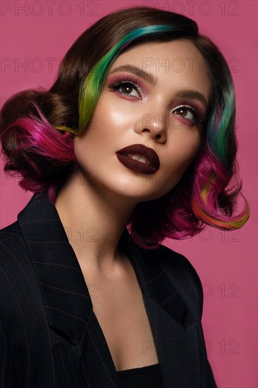 Portrait of beautiful woman with multi-colored hair and evening make-up and hairstyle. Beauty face