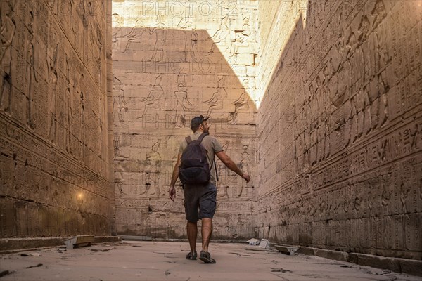 A young tourist visiting the beautiful temple of Edfu in the city of Edfu